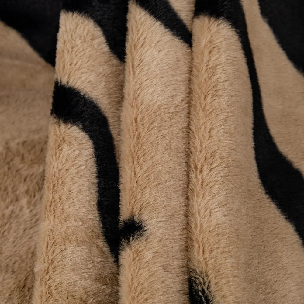 Zebra pattern thickened flannel sofa cover in caramel colour with matching pillowcase on a grey sofa.