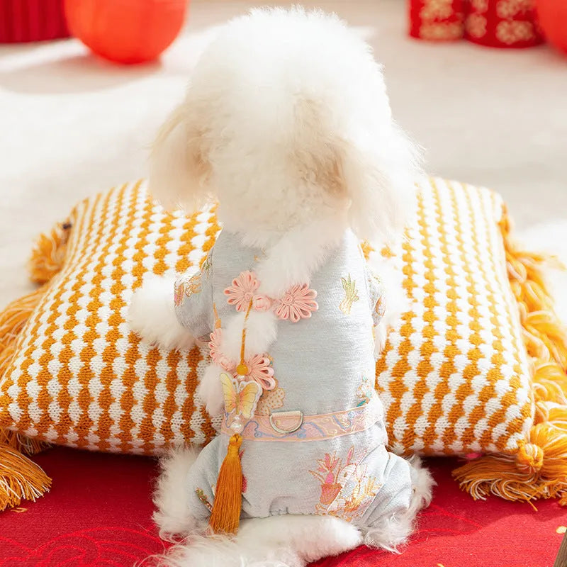 Light blue cheongsam pet coat with embroidered floral motifs, butterfly ornament, golden tassel, faux fur trim, and metal leash ring