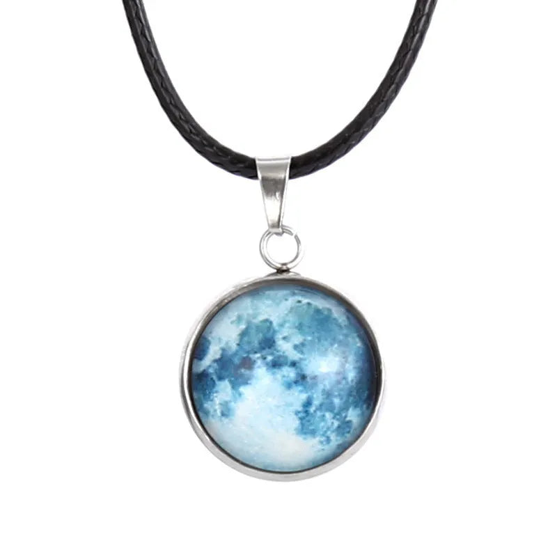 Luminous moon and star constellation pendant necklace with a silver-tone chain on a black background.