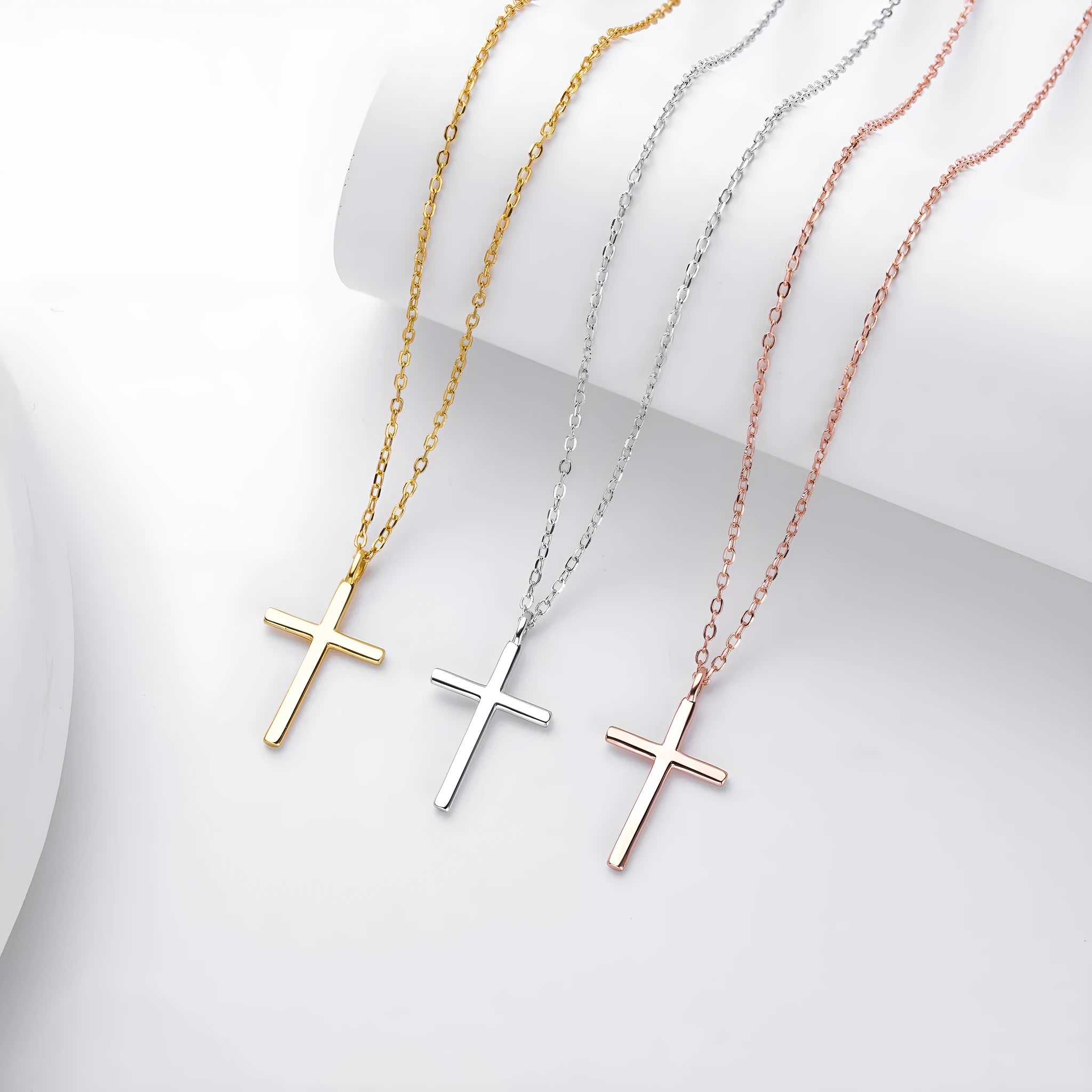 S925 sterling silver necklace with a simple glossy cross pendant on an O-shaped chain in a choice of gold, platinum, or rose gold plating.