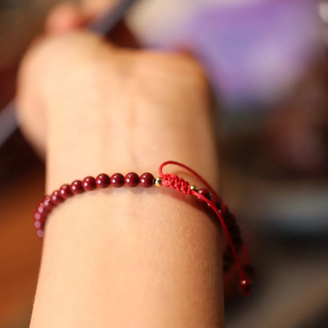 Women's handmade cinnabar bracelet with purple gold sand design and Chinese auspicious patterns.