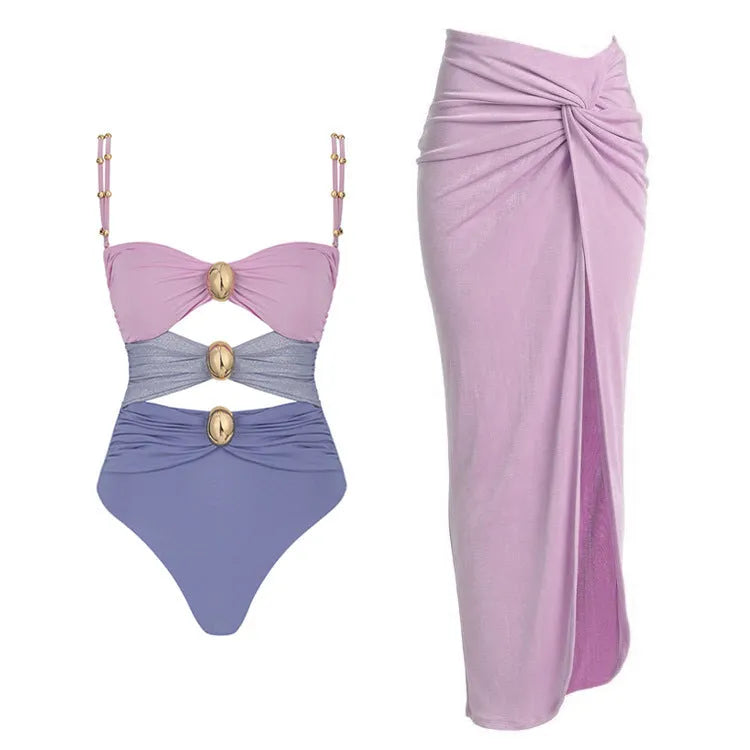 Women's black sleeveless one-piece swimsuit with a skirt and gold button detail.