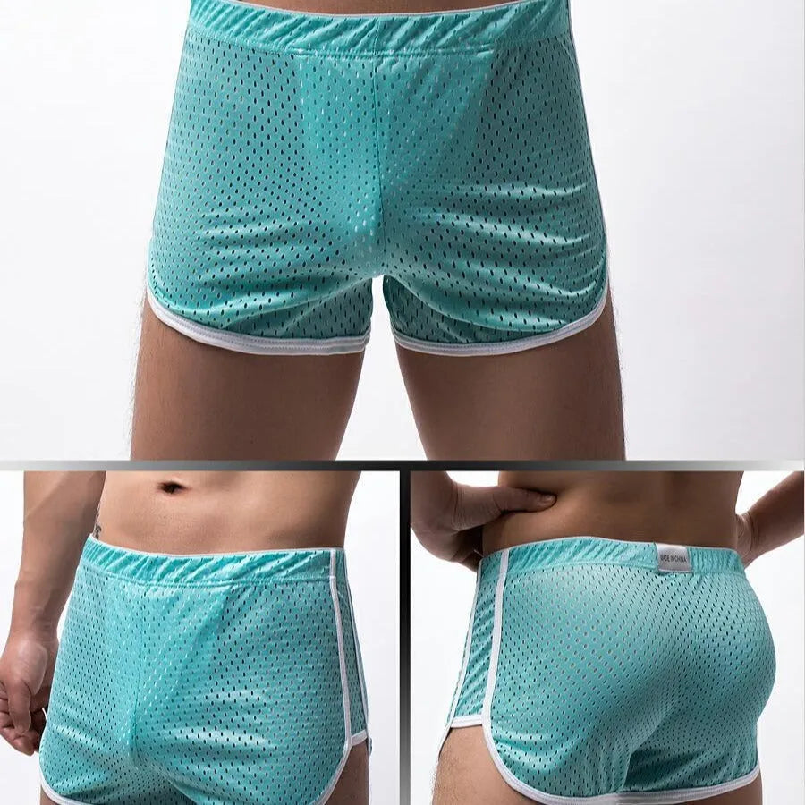 Men's grey three-point boxer shorts with a mid-rise waistband laid flat on a table.