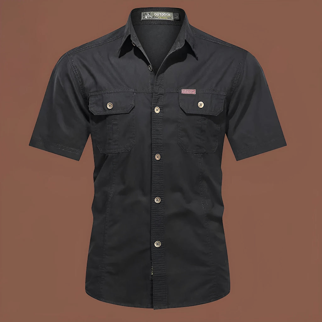 Man wearing a loose-fitting short sleeve cotton work shirt in a cardigan style.