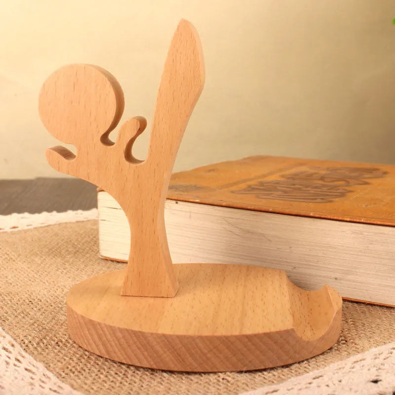 Solid beech wood phone holder with resin puppy decoration and a pound coin in the integrated slot.