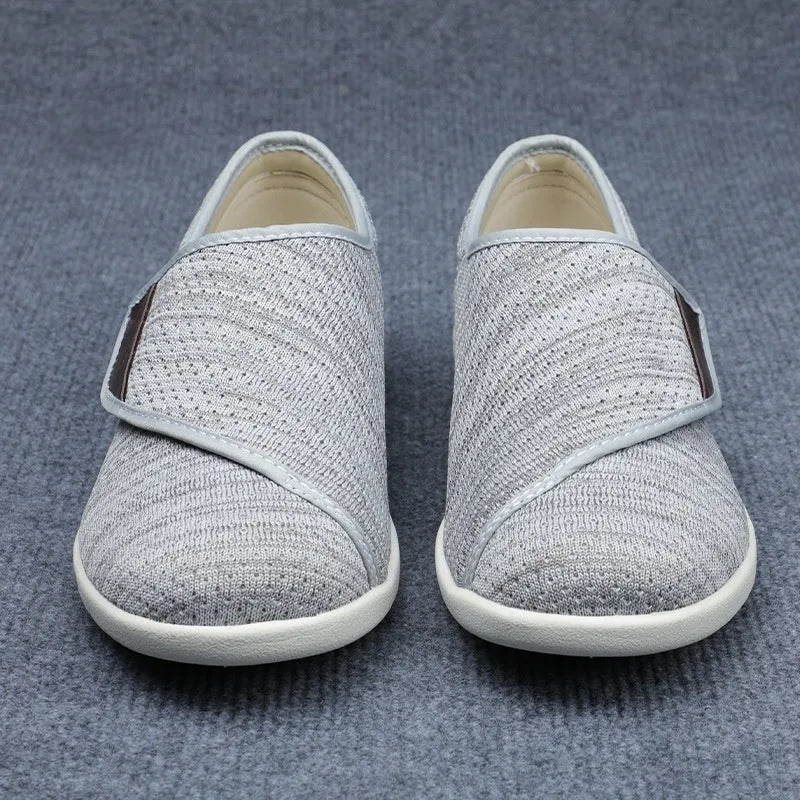 Unisex leisure shoe with hook-and-loop strap on textile upper and foam rubber sole.