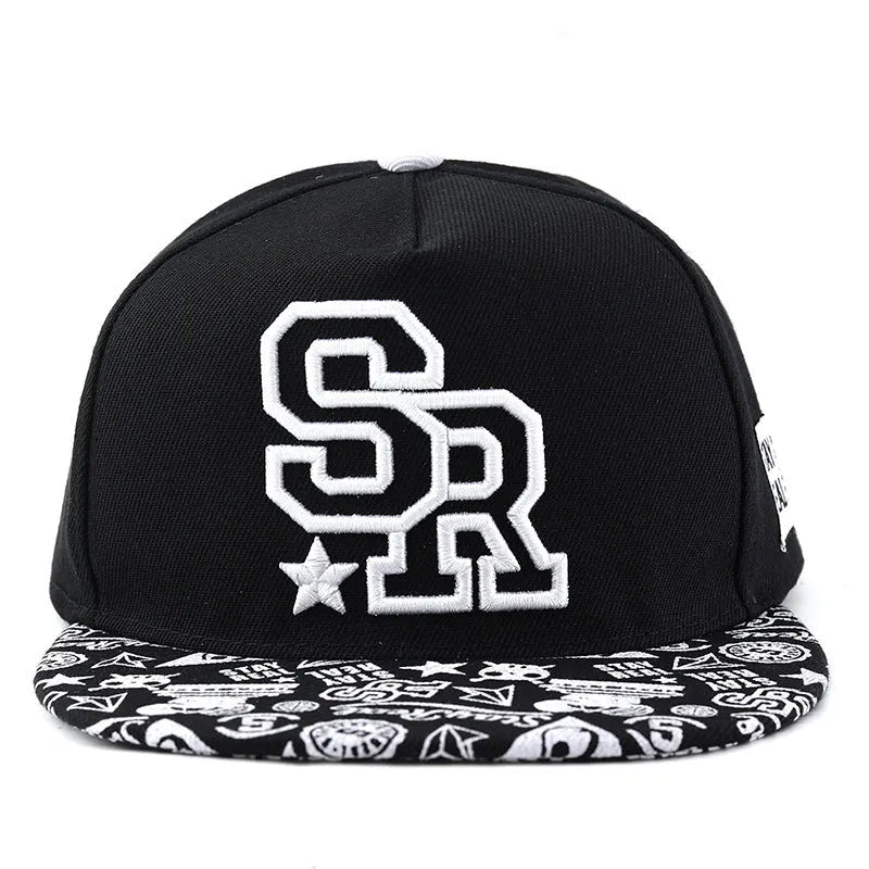 White and black adjustable cotton baseball cap with embroidered letters on the front, showing dome crown and adjustable strap.