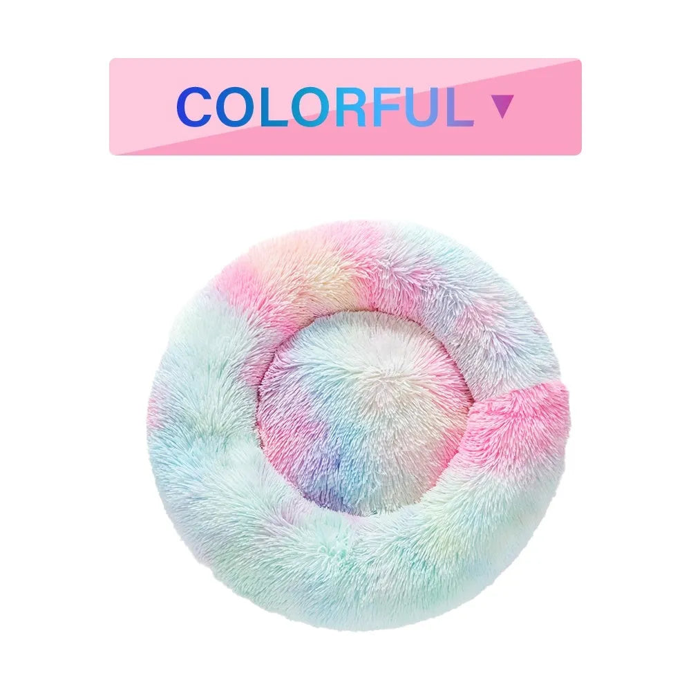 A fluffy, round donut-shaped dog bed with a raised rim in long plush fabric.