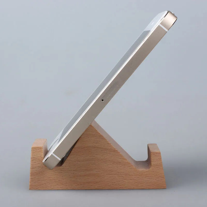 Solid beech wood phone holder with resin puppy decoration and a pound coin in the integrated slot.
