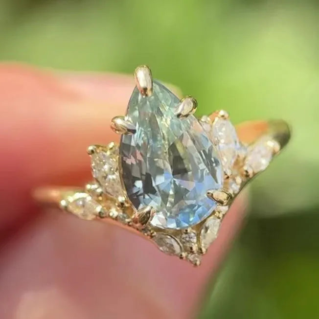 Gold-tone alloy floral ring with blue aquamarine-coloured crystal and diamond inlay for women