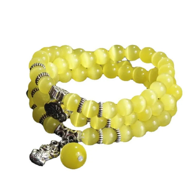 Women's opal bracelet with three interlocking rings, a Lucky Cat charm, and geometric stones in various colours.