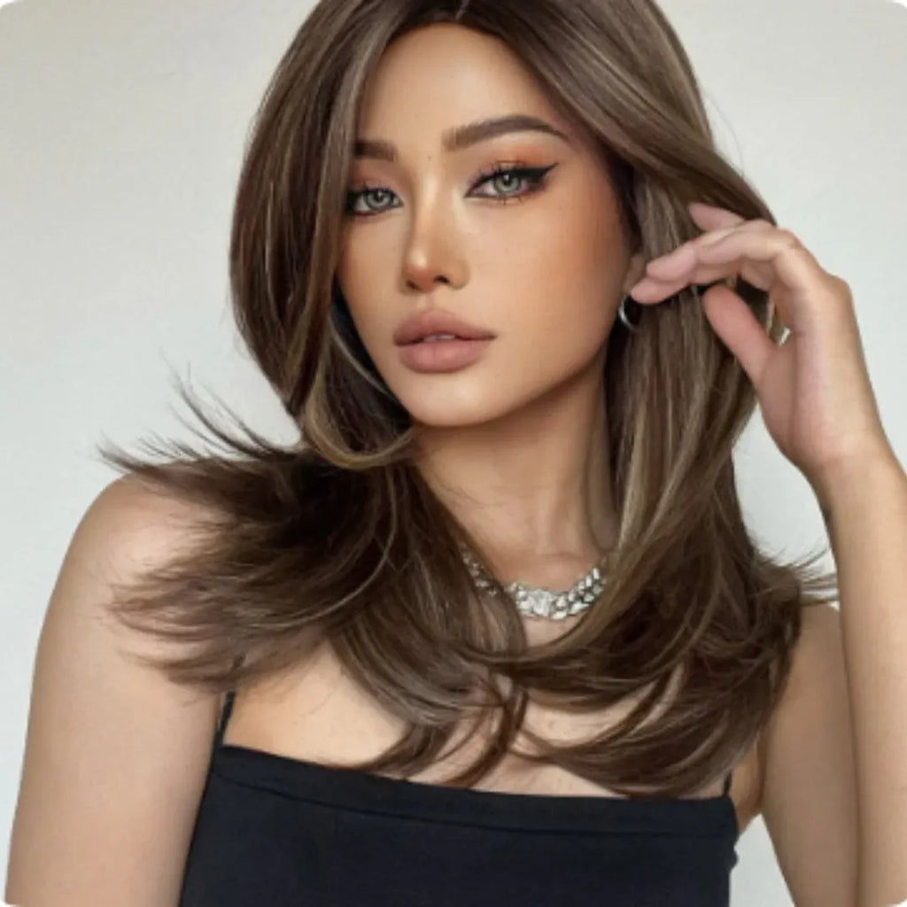 Mid-length curly synthetic wig with long bangs in a gradient colour.