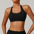 Women's black halter neck sports bra with removable padding for yoga and low-impact workout.