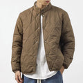 Men's black diamond lattice winter padded jacket showing extended length and loose fit