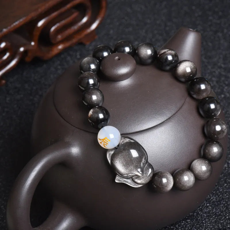 Natural black obsidian zodiac bracelet with 10mm beads on an elastic cord in three style variations.