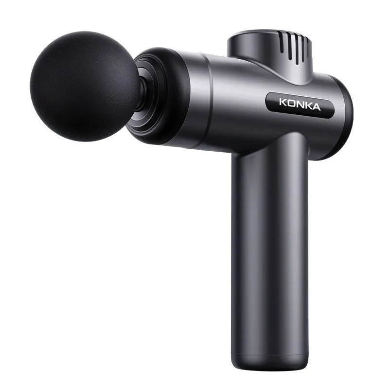 Konka V19 grey percussion massage gun with set of interchangeable foam and silicone massage heads on a table.