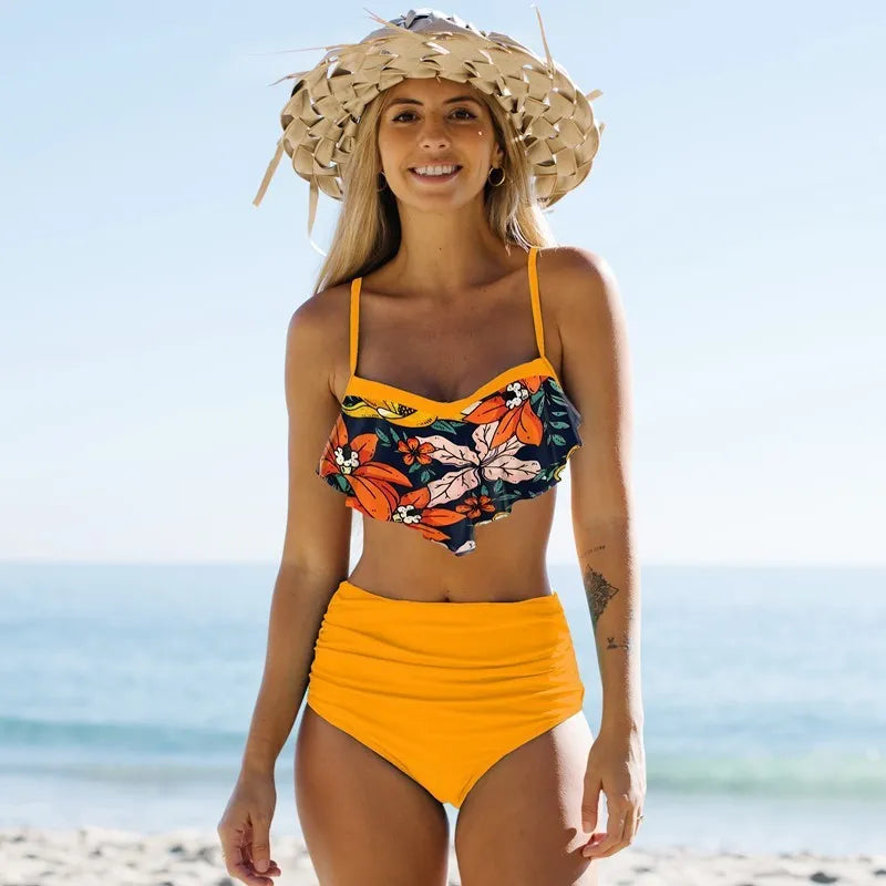 Women's blue split bikini swimsuit with high-waist pleated pants and floral pattern