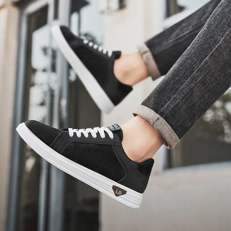Men's black snake pattern PU leather casual sneakers with round toe and flat rubber sole on a white background