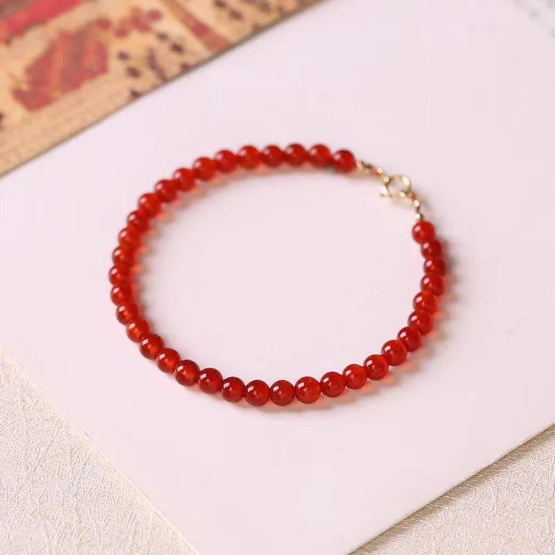 Ultra-thin red agate bracelet for women on a white background.