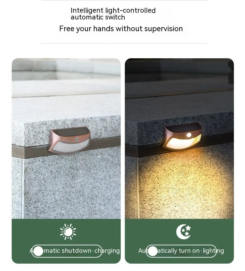 Solar-powered outdoor wall lamp with a smiling face design in a garden setting.