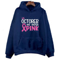 Man wearing a dark blue sweatshirt hoodie with a white retro 'I'm A Survivor' hot stamp print on the front.