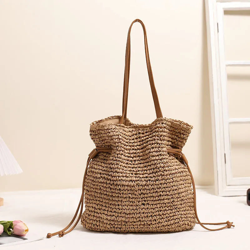Large straw drawstring shoulder bag with polyester lining and mobile phone pocket in beige or coffee