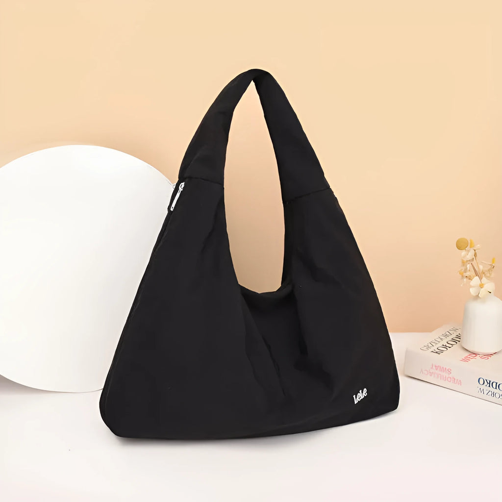 Women's heart-shaped nylon crossbody bag in black, shown from the front.