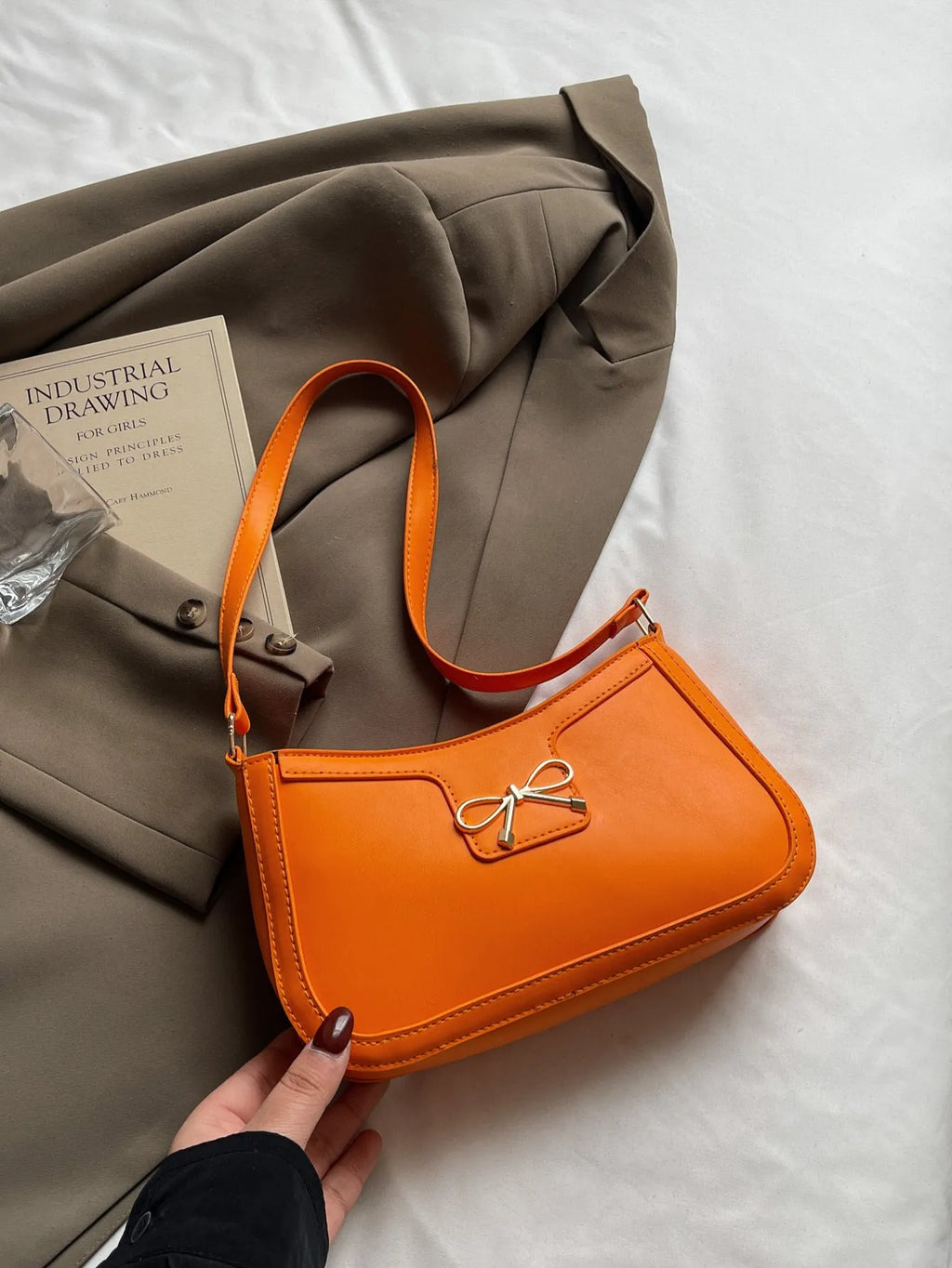 Western style PU leather shoulder bag in horizontal square shape with bow decoration, shown in rose pink colour.