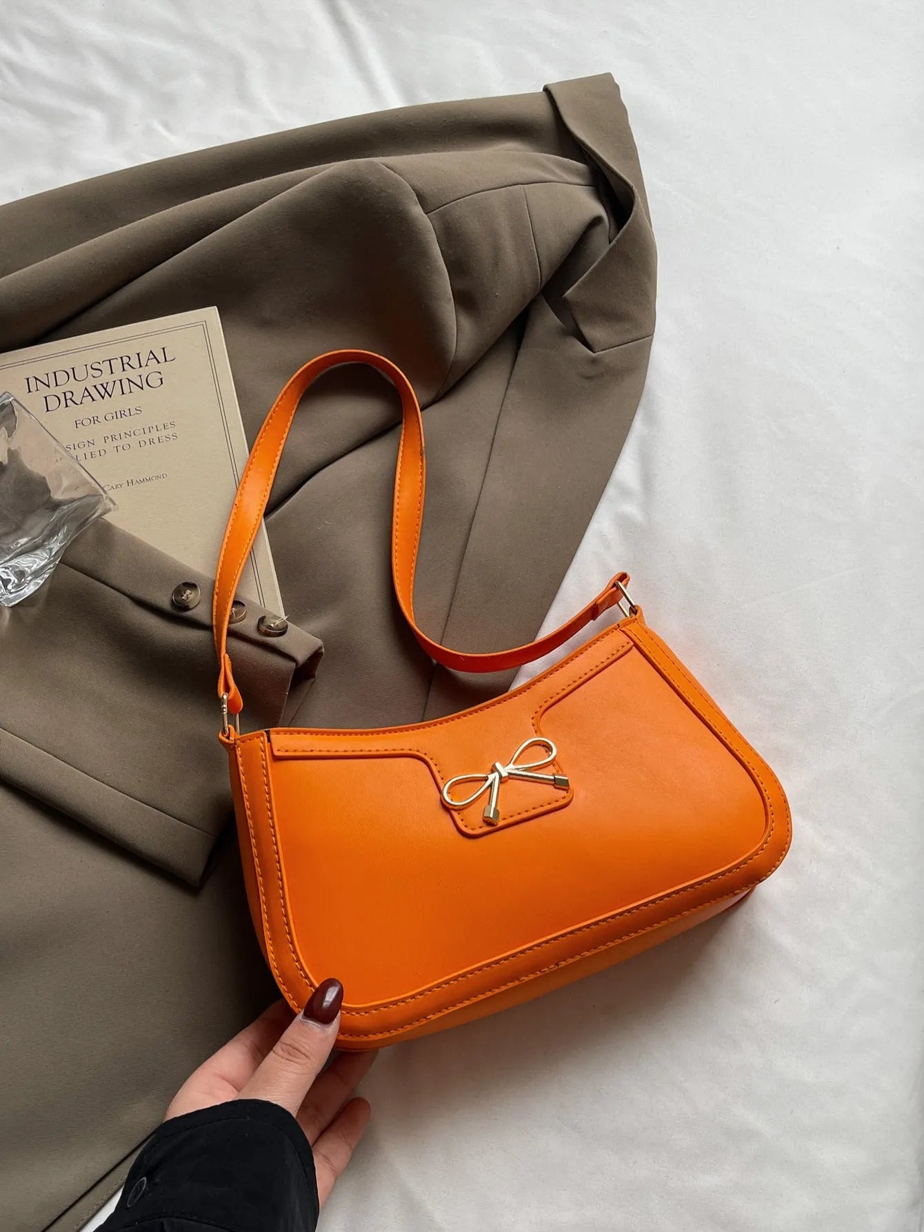 Western style PU leather shoulder bag in horizontal square shape with bow decoration, shown in rose pink colour.