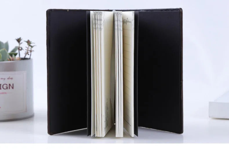 PU leather A5 notebook with three-dimensional embossed cover and bronze highlights, open to beige pages