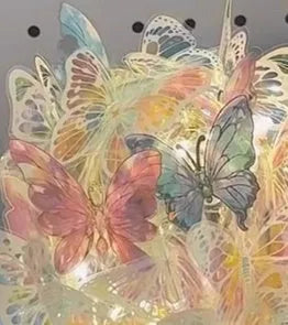 Handmade butterfly night light DIY kit with glass shade and raw wood base on a bedside table.