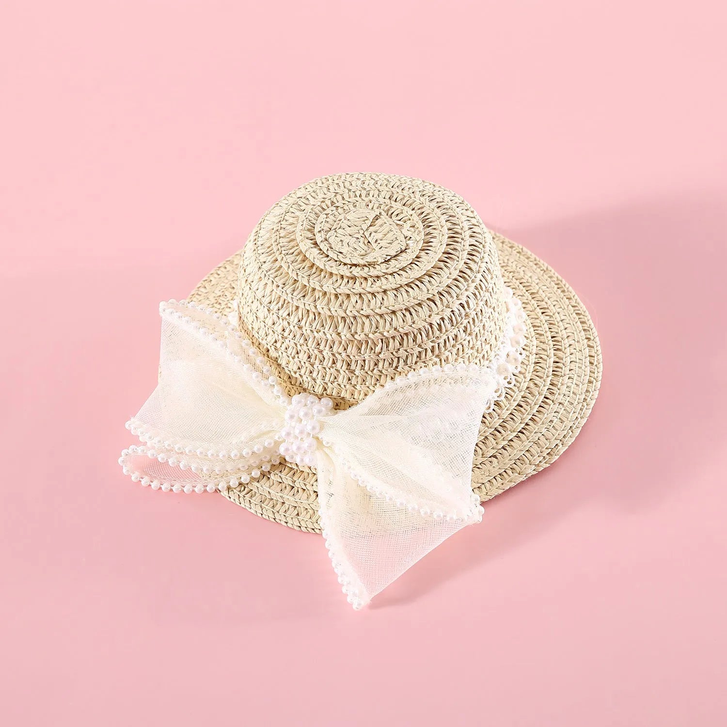 Pink pearl bow woven straw hat for a cat, shown in size S (13cm) on a mannequin head.