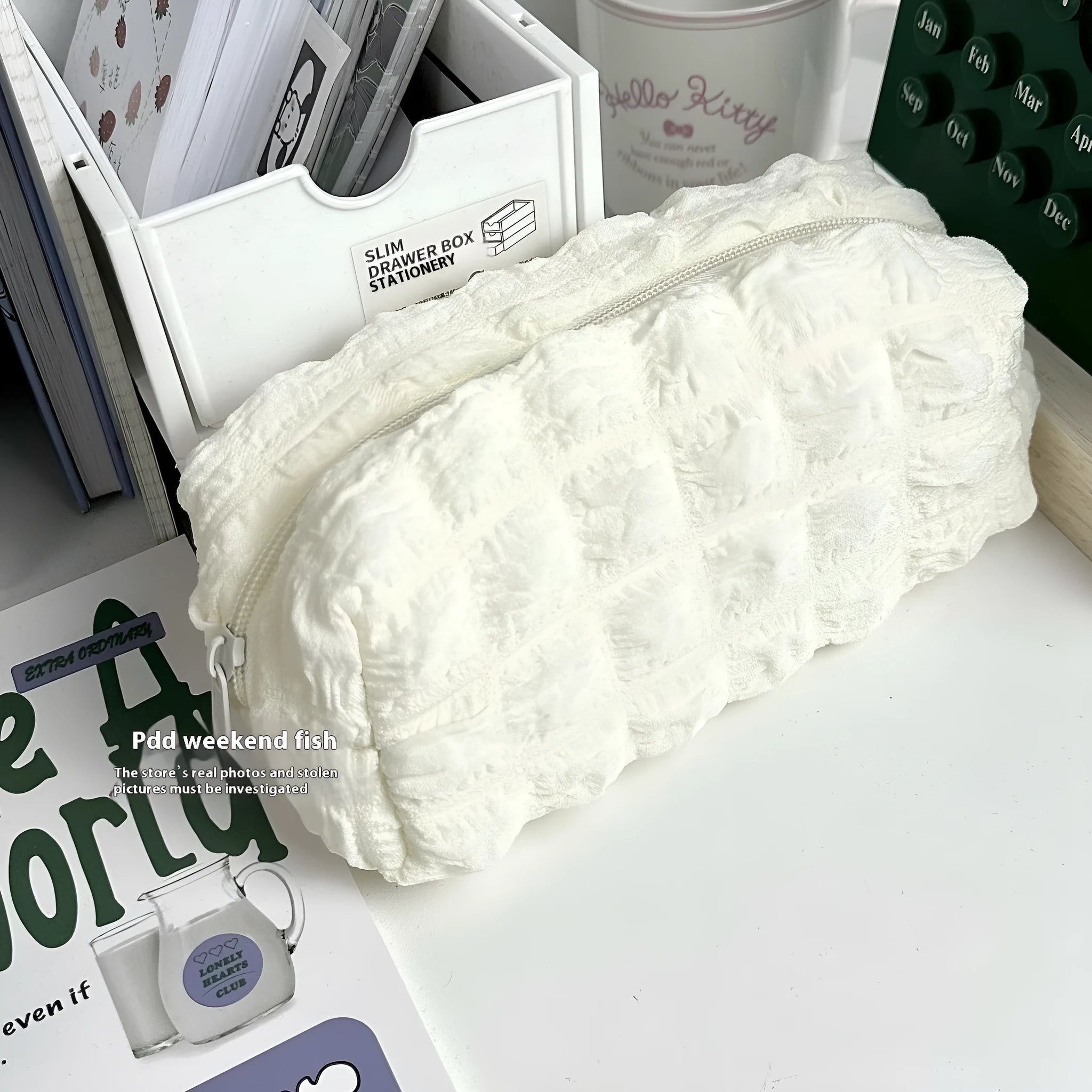 Beige fabric pencil case with a soft, rounded cream puff design and a zipper.