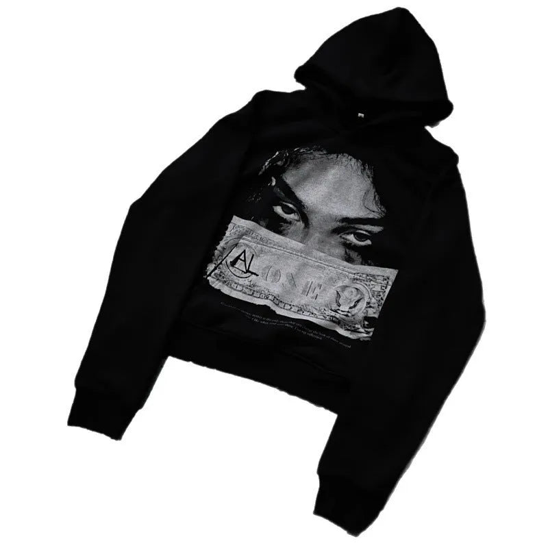Black women's loose-fit hoodie with a cartoon print, shown in a casual setting.