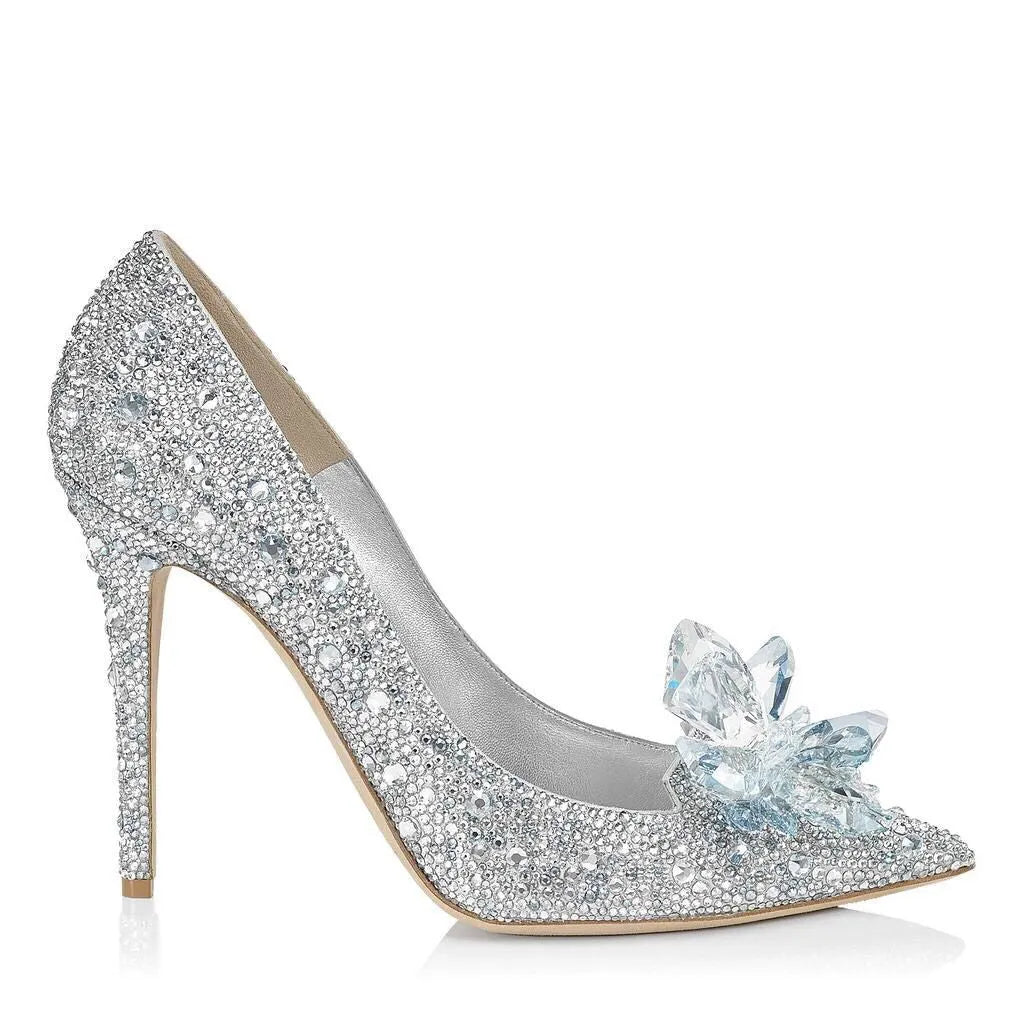 Gold women's stiletto heels with sequin upper, rhinestones, a bow, and a pointed toe.