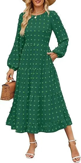 A woman wearing a beige high waist long sleeve dress with ruffled sleeves, a round neck, and a solid colour design.