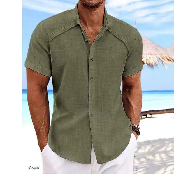 Man wearing a solid colour Hawaiian casual short sleeve shirt in a cotton blend fabric.