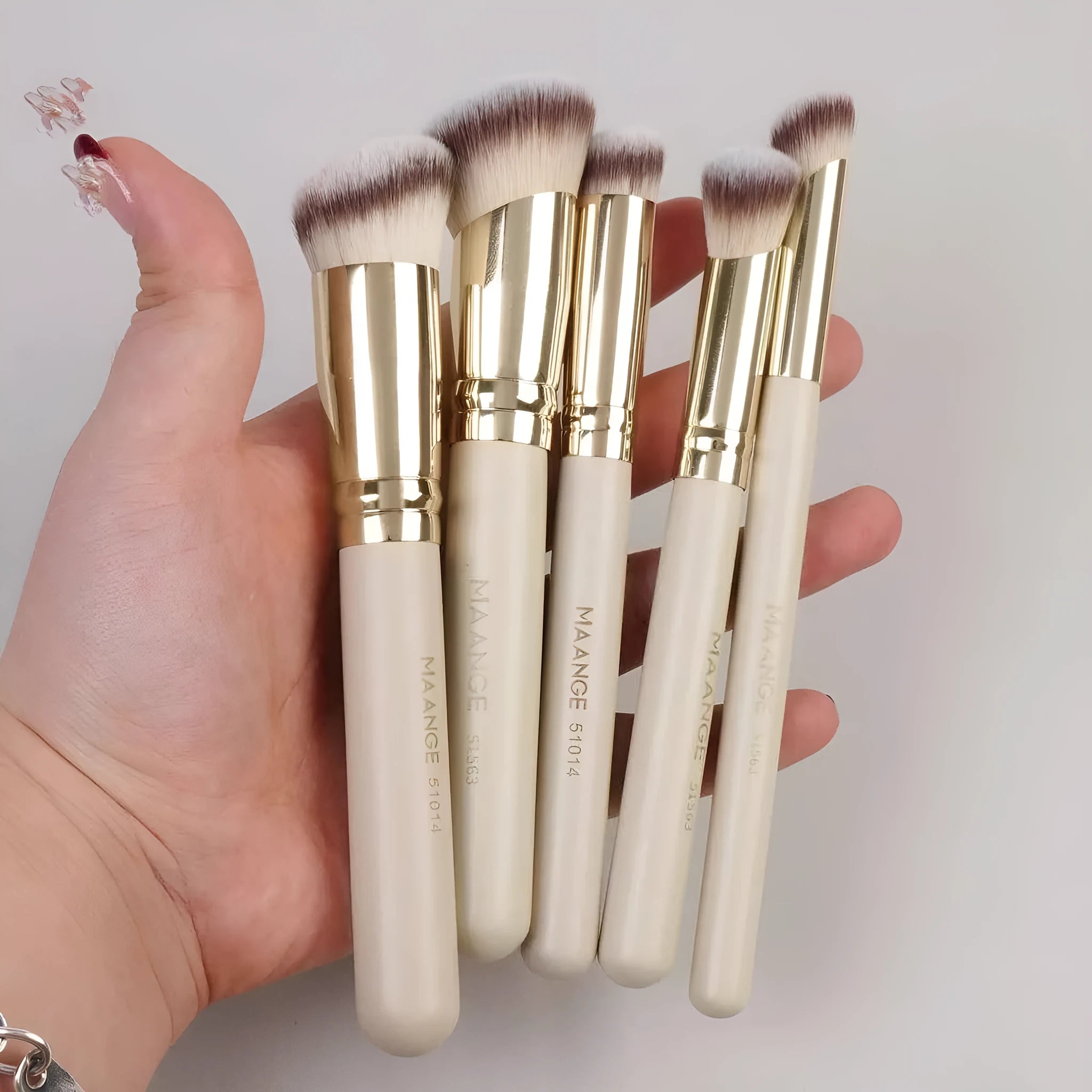 MAANGE five-piece angled blush and foundation makeup brush set with apricot handles.