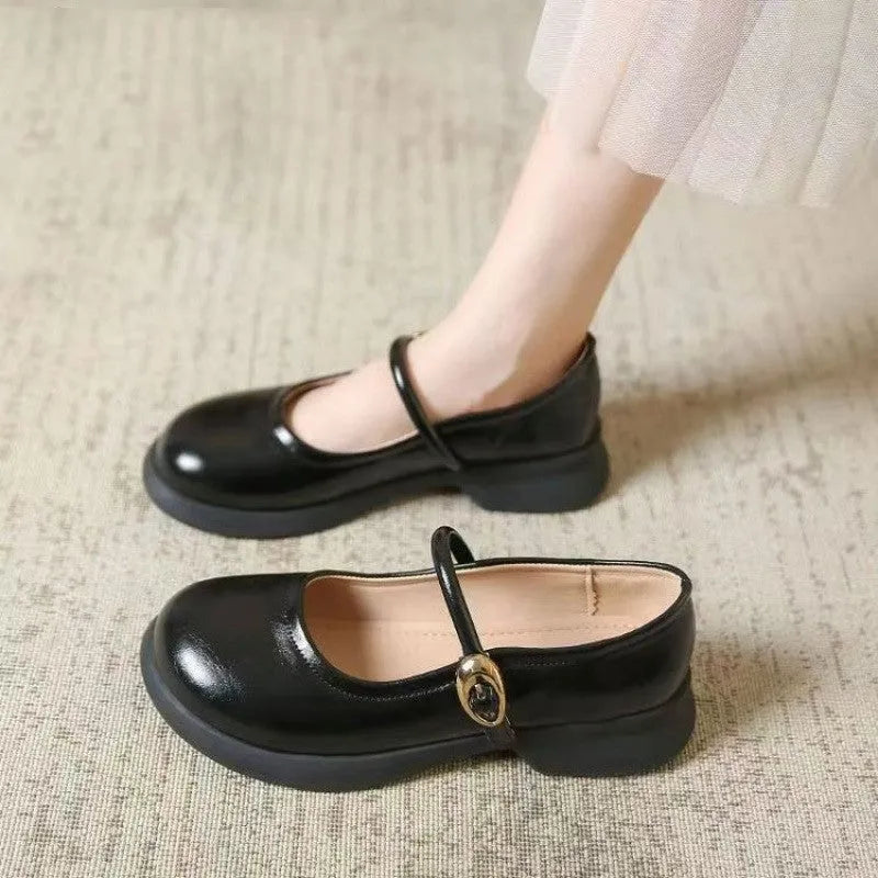 Flat fairy style leather shoes with wedge heel and round toe in black, white, and light brown colours.