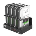 External four-bay hard drive docking station for 2.5-inch drives with cables and power adapter.