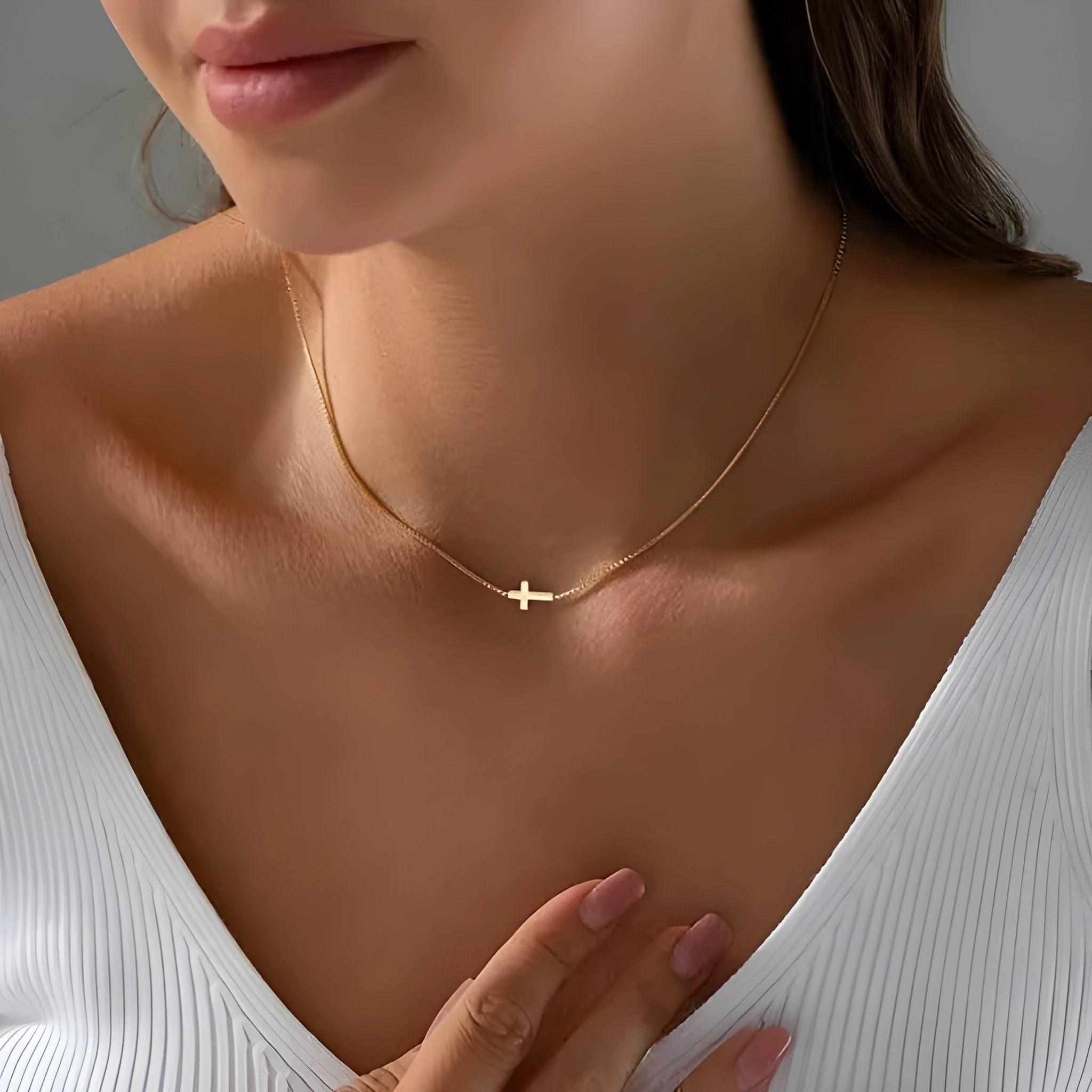 Miniature cross pendant necklace for women in alloy, dainty style on display