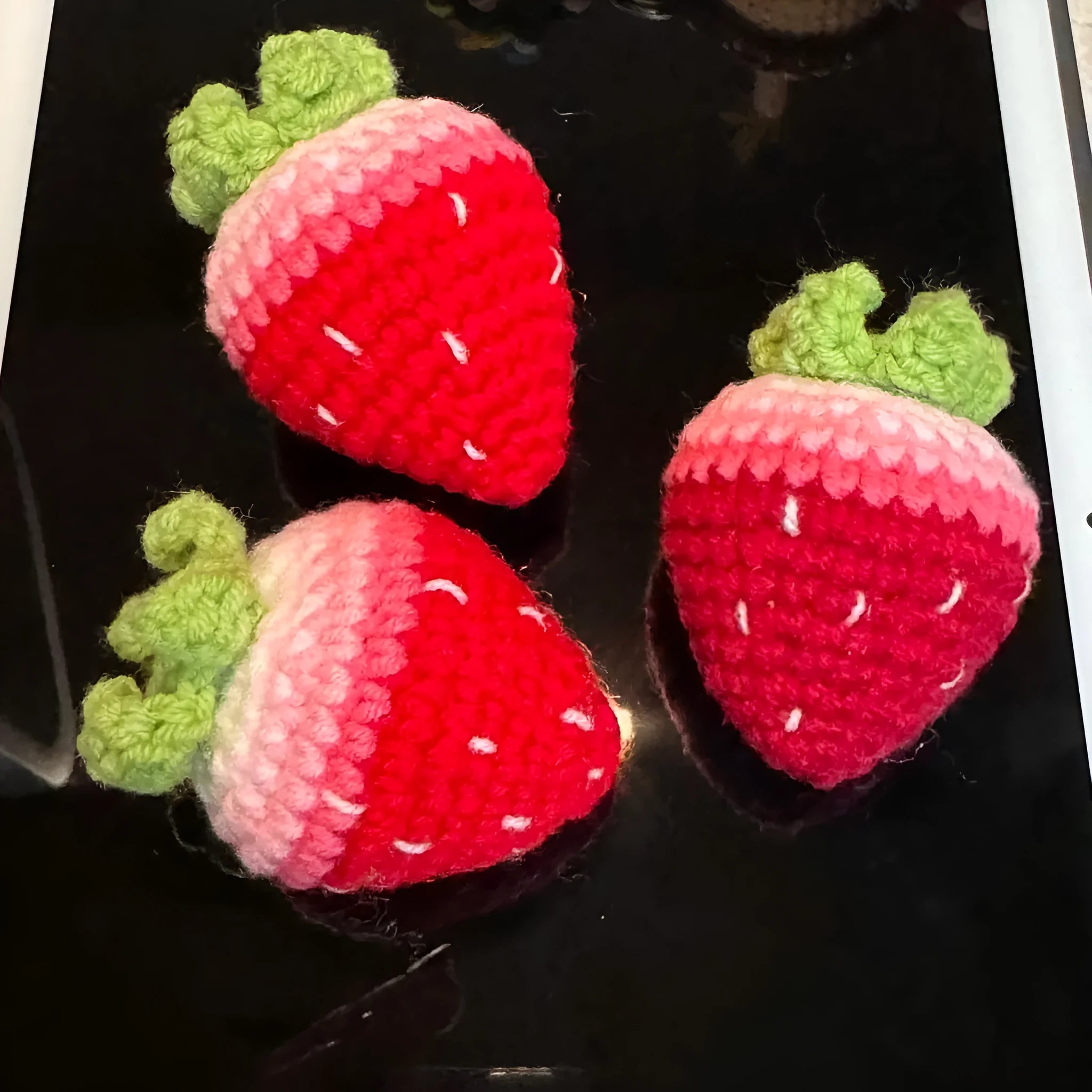 Soft plush strawberry-shaped pendant keychain in pink or red colour.