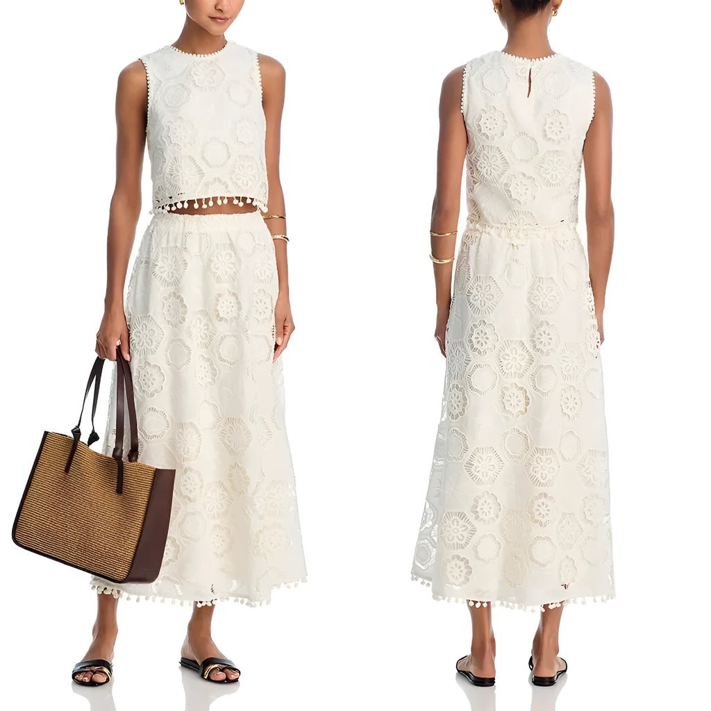 White women's sleeveless top and long skirt suit with embroidery details