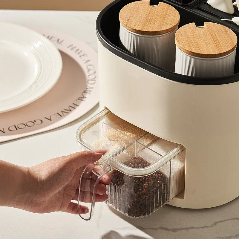 Plastic 360-degree rotating kitchen storage organiser with four compartments holding cutlery and a spice box