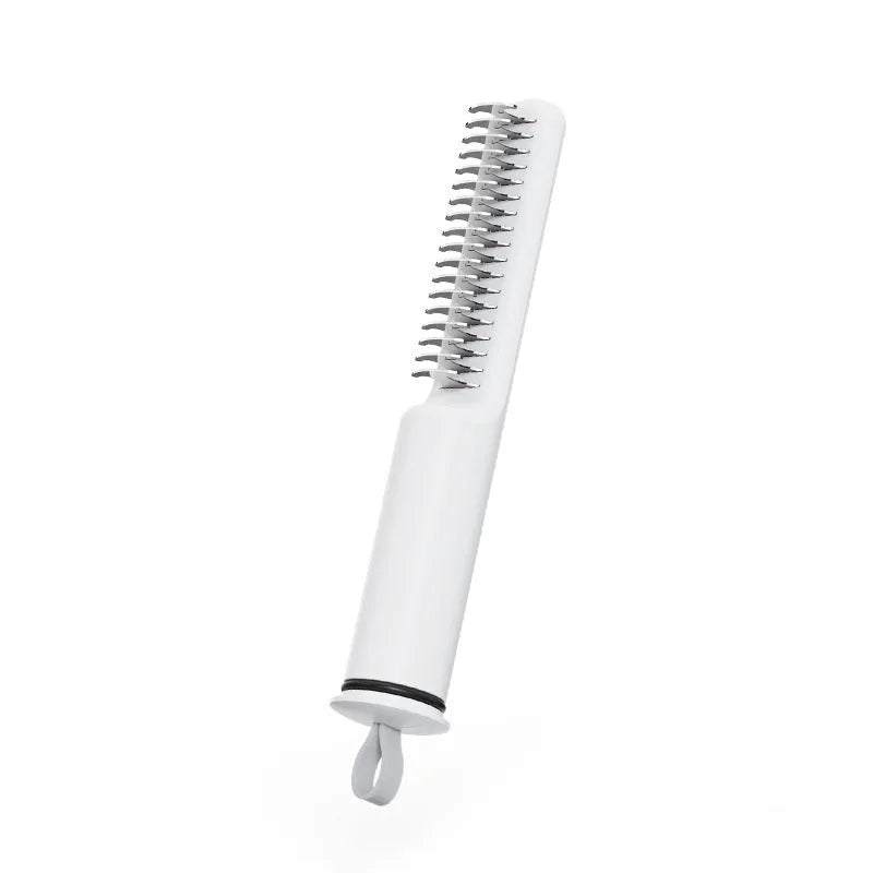 Stainless steel pet detangling comb with rake teeth on a pink handle for removing knots from dog hair.