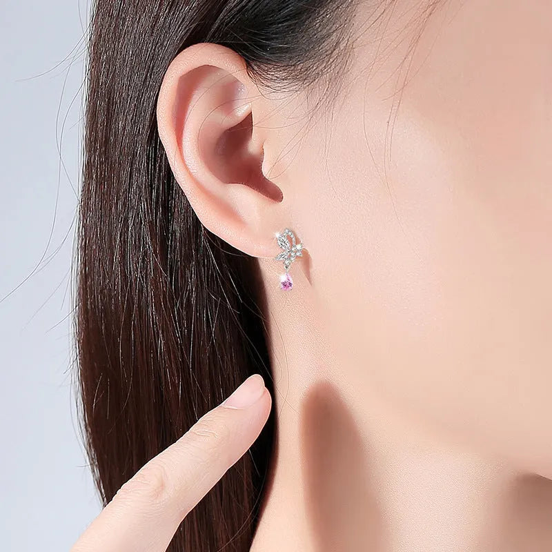 Silver stud earrings with butterfly shape and crystal accents in colour E0141