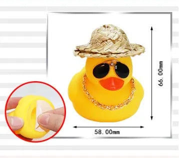 Yellow duck car ornament with straw hat and sunglasses on car dashboard
