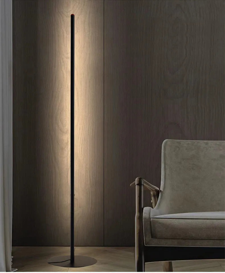 Simple modern vertical aluminium alloy floor lamp with LED light in a living room corner.