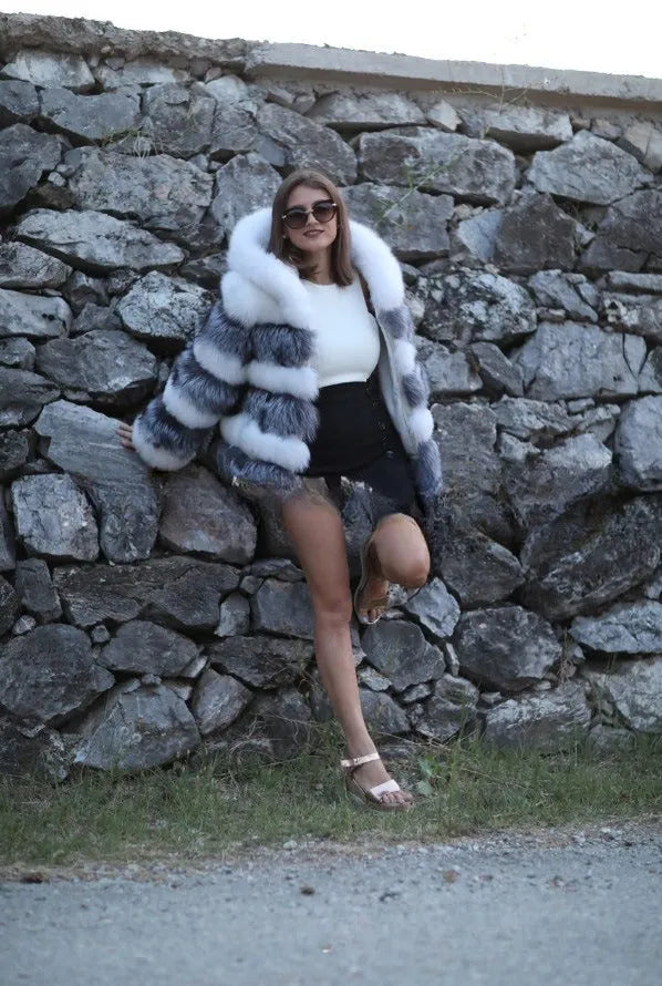 Women's loose brown faux fur hooded coat on a model, street fashion style.