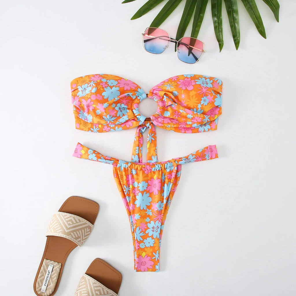Women's floral print tube top bikini swimsuit with matching briefs on a neutral background.